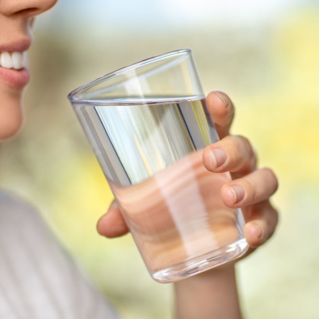 Person drinking a glass of water