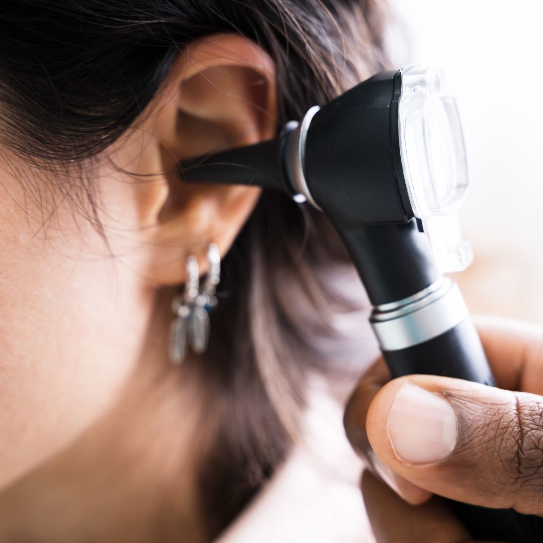 Doctor looking in patient ear